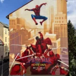 Živá nástenná maľba na budove zobrazuje Spider-Mana, ako sa hojdá mestskou krajinou nad bojovníkmi v červenom, a stelesňuje tak akciu a dobrodružstvo.